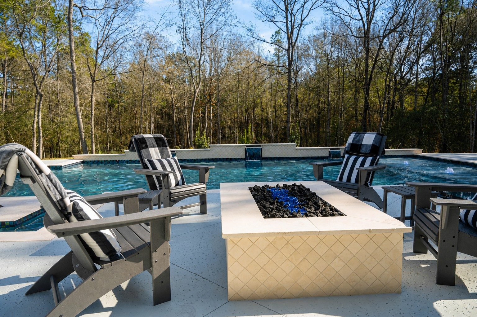 Detail of the glass-tile waterline and pool finish in afternoon light